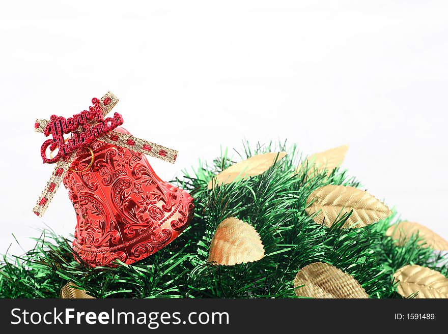 Red christmas bell with golden leaves and green ribbons over white background. Red christmas bell with golden leaves and green ribbons over white background