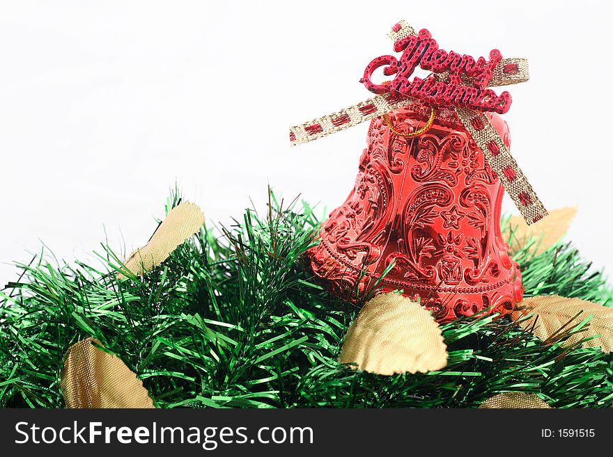 Red christmas bell with golden leaves and green ribbons over white background. Red christmas bell with golden leaves and green ribbons over white background