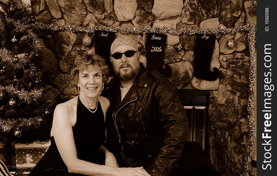 Biker in leathers with a woman in a long black dress. Biker in leathers with a woman in a long black dress