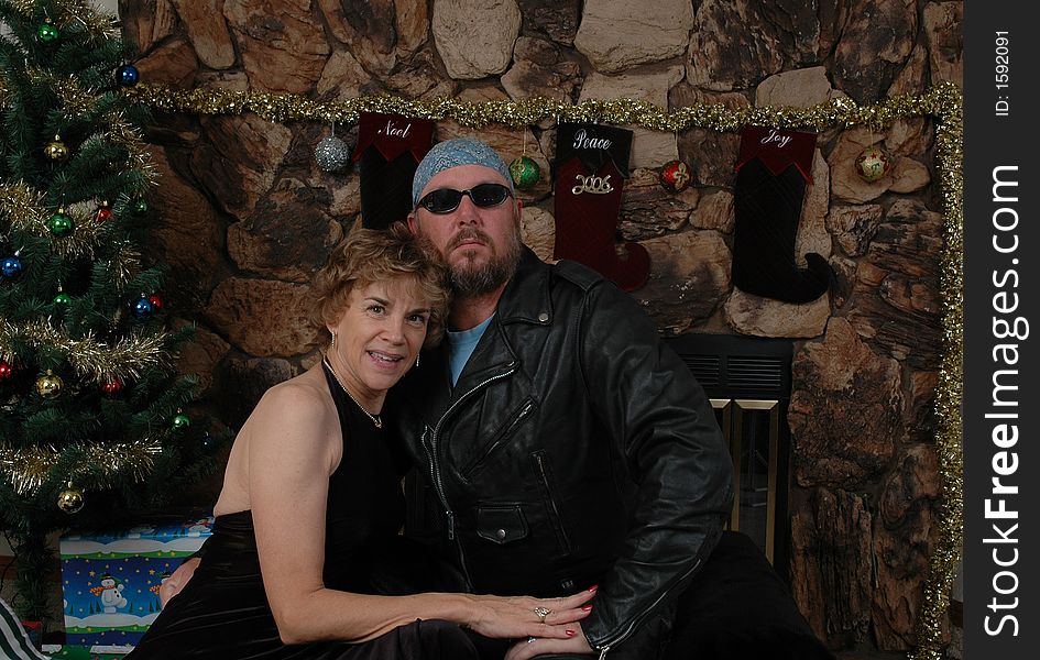 Biker in leathers with a woman in a long black dress. Biker in leathers with a woman in a long black dress