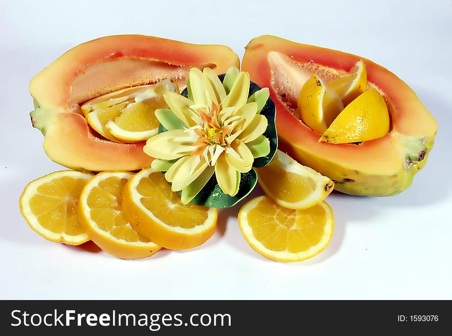 Fresh papaya and orange slices on white background. Fresh papaya and orange slices on white background