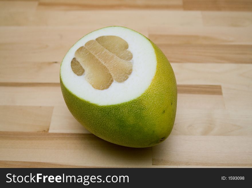 Grapfruit on a wooden kitchen table. Grapfruit on a wooden kitchen table
