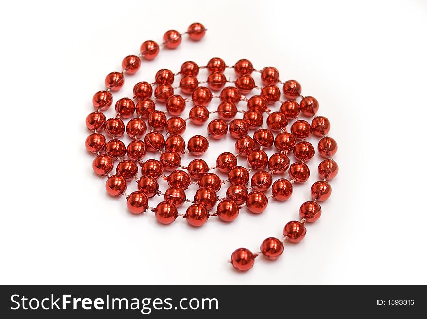 Arrangement of red beads on white background