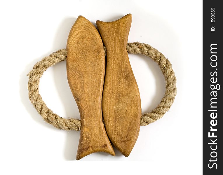 Hotpad for hot dishes made of wood in shape of 2 fishes