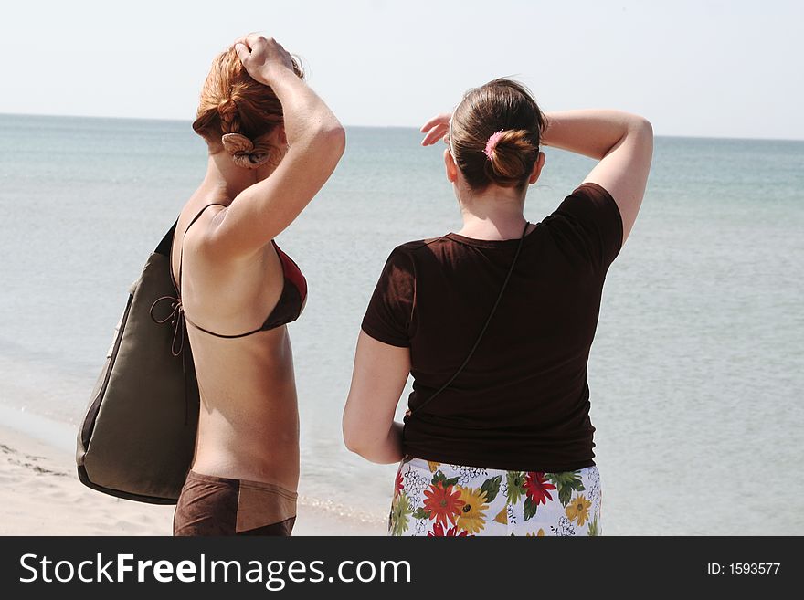 Two girls looking at a sea horizon