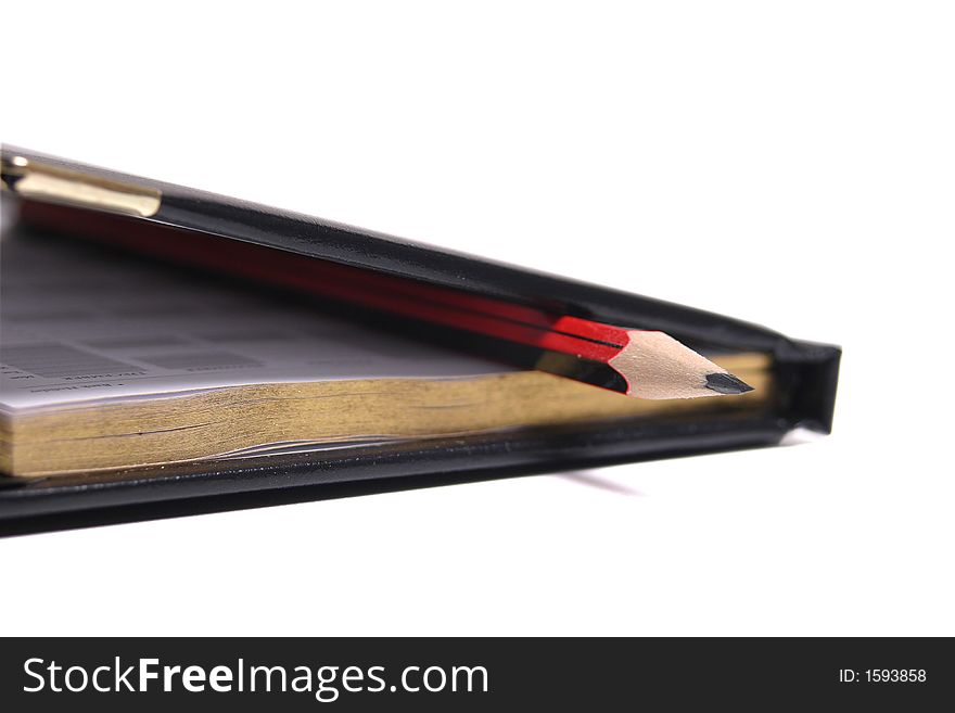 Isolated diary and red pencil. Isolated diary and red pencil
