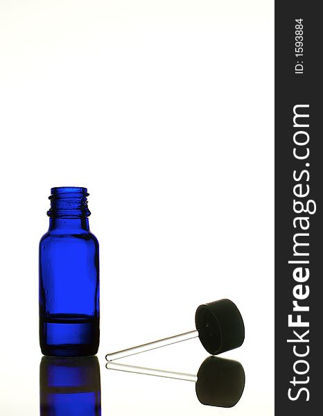 Blue glass bottle for fragrant oils with applicator. Blue glass bottle for fragrant oils with applicator.