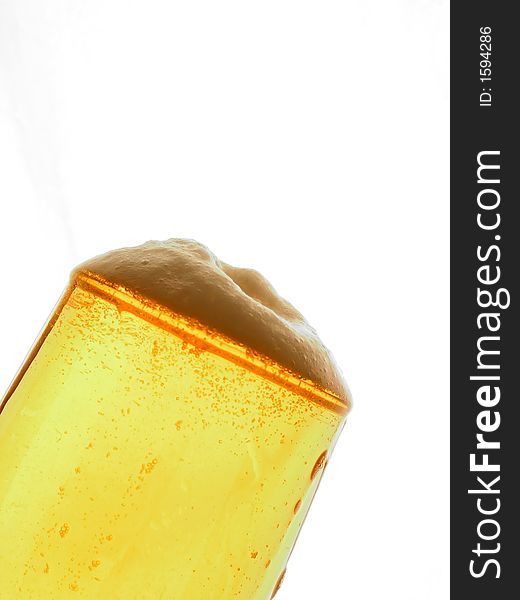 A part of a glass of foaming beer. A part of a glass of foaming beer