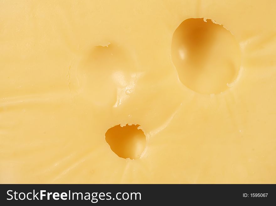 A closeup of a chunk of swiss cheese. A closeup of a chunk of swiss cheese