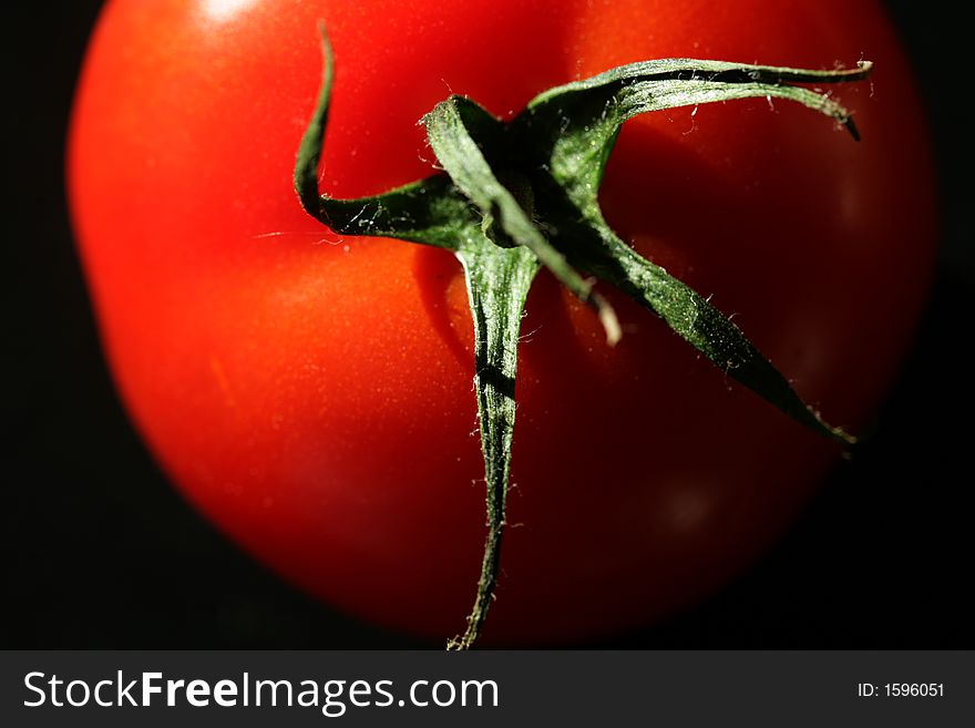 Tomato close up in natural light with dark background. Tomato close up in natural light with dark background