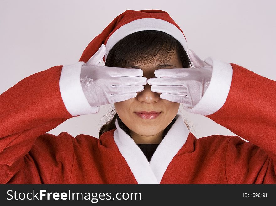 Asian girl showing See No Evil in Christmas Attire.