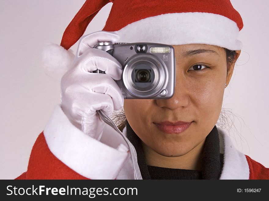 An Asian female santa claus with camera.