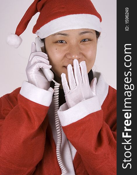 Asian female santa claus making a phone call. Asian female santa claus making a phone call.