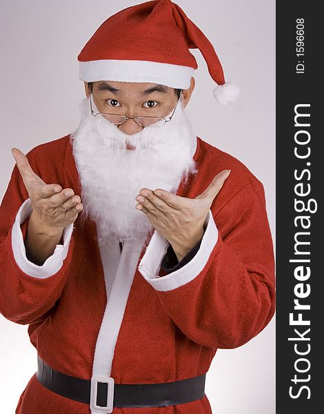 An Asian santa claus welcoming with both hands.