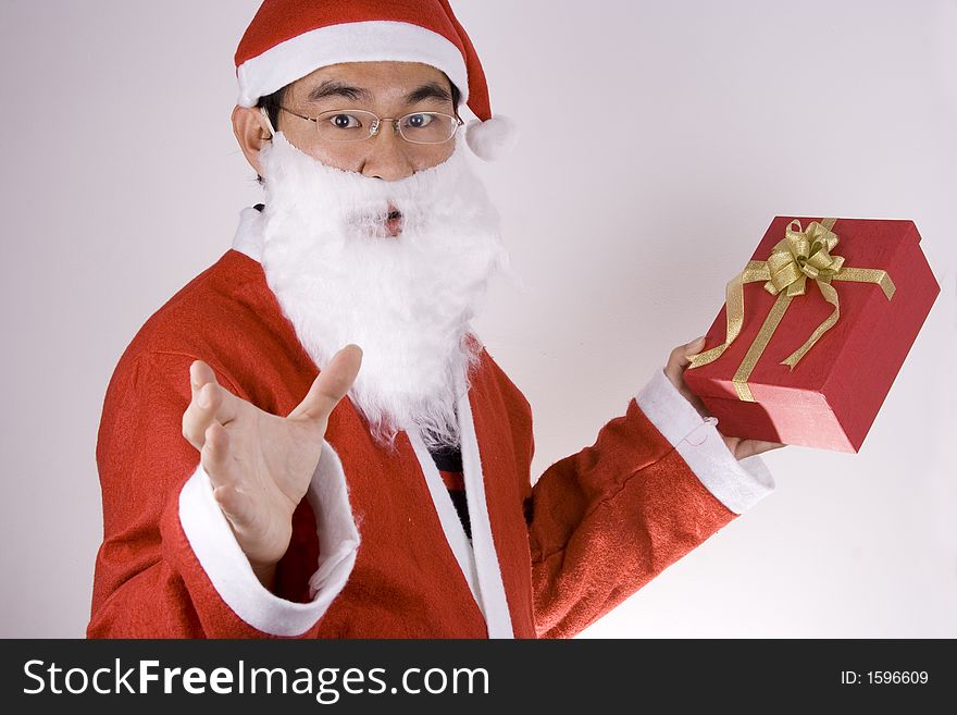 Asian Santa Claus holding a gift box. Asian Santa Claus holding a gift box.