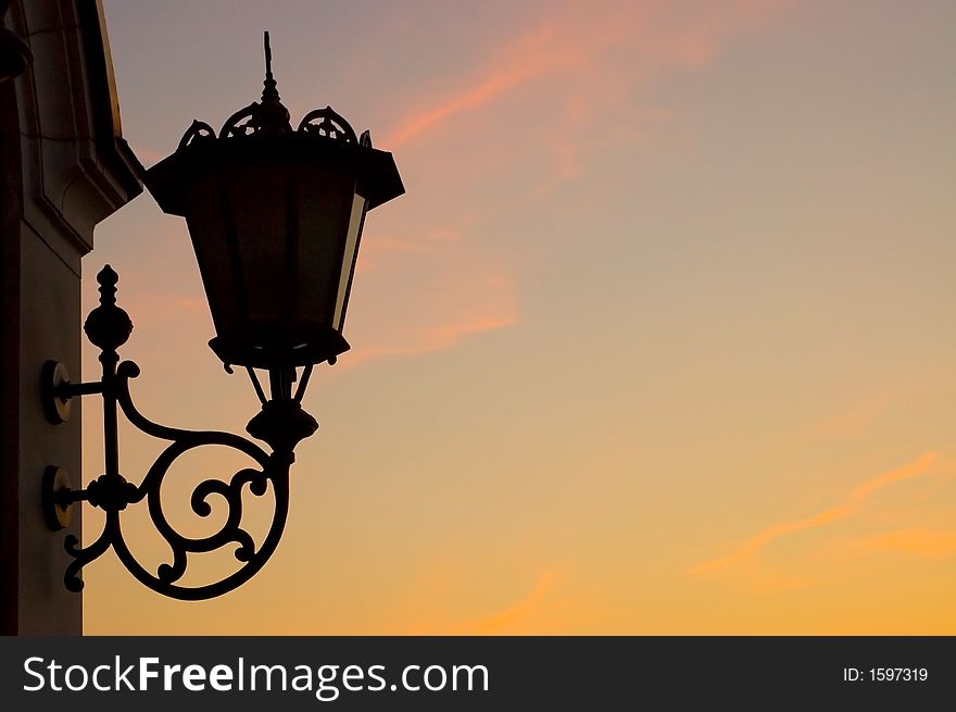 Old street lamp against sky background, silhouette