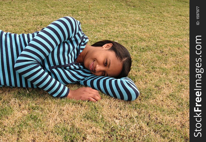 Jasmine is relaxing in the grass on a nice fall day. Jasmine is relaxing in the grass on a nice fall day