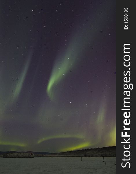 Sporadic displays of aurora borealis in dark night sky. Sporadic displays of aurora borealis in dark night sky