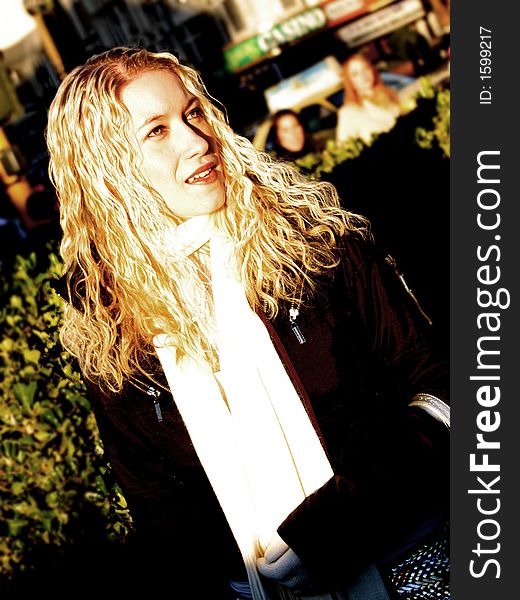 Outdoor high contrast Portrait of beautiful blond woman in natural light. Urban enviroment.