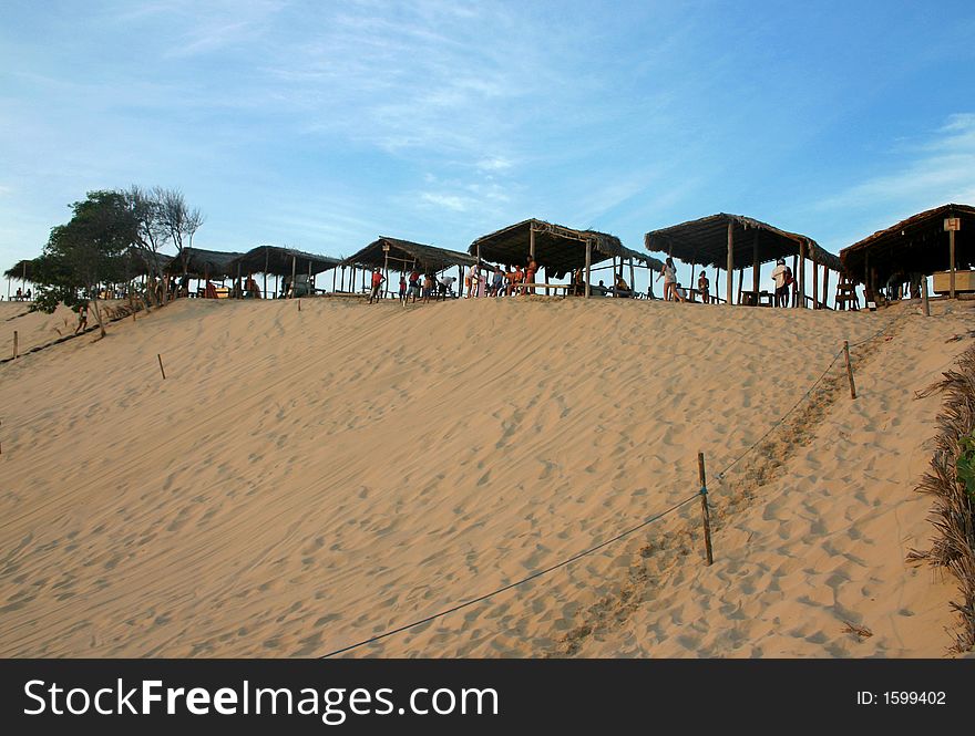 Sand dune with huts on top
