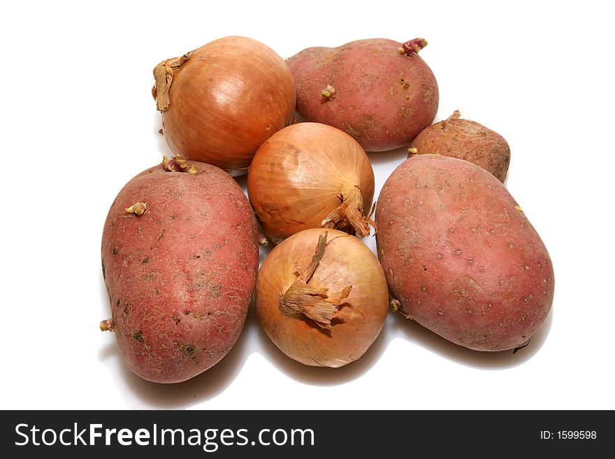 Bunch of potatoes and onions isolated over white