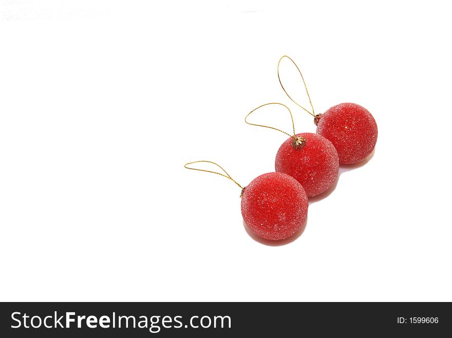 Three red christmas balls isolated over white