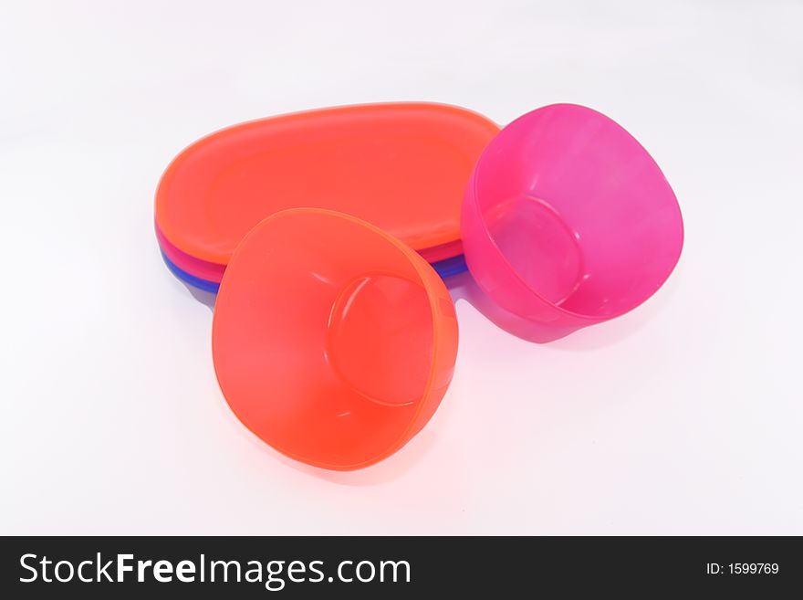 Colorful plastic plates and cups isolated over white