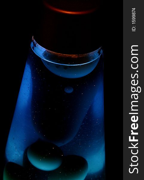 Blue lava lamp glowing in the dark