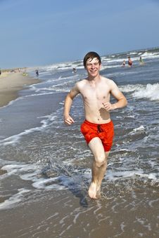 Boy Running Along The Beautiful Beach In The Waves Royalty Free Stock Photography