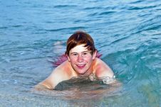 Boy Lying At The Beach Enjoys The Surf Of The Sea Stock Photography Boy Lying At The Beach Enjoys The Surf Of The Sea Stock Photography