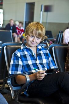 Boy Is Waiting For Departure At The Airport Royalty Free Stock Image Boy Is Waiting For Departure At The Airport Royalty Free Stock Image
