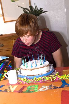Boy Blows Out His Birthday Candles Royalty Free Stock Photos