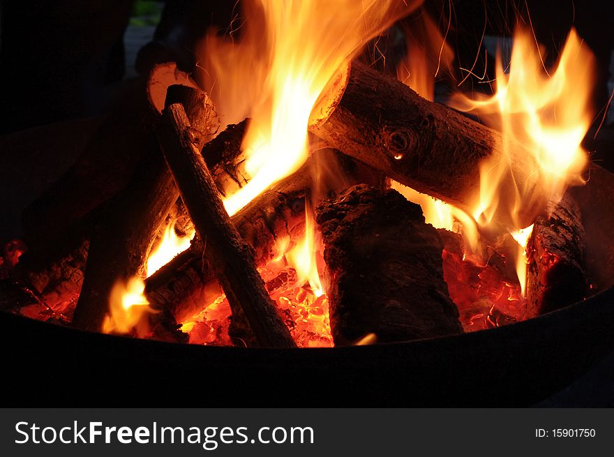 Fire with Flames coming from Log Pieces, spark