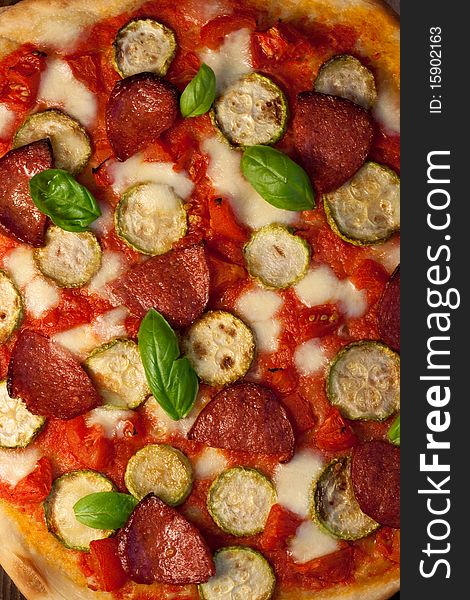 Pizza with courgettes, salami and tomatoes. Pizza with courgettes, salami and tomatoes