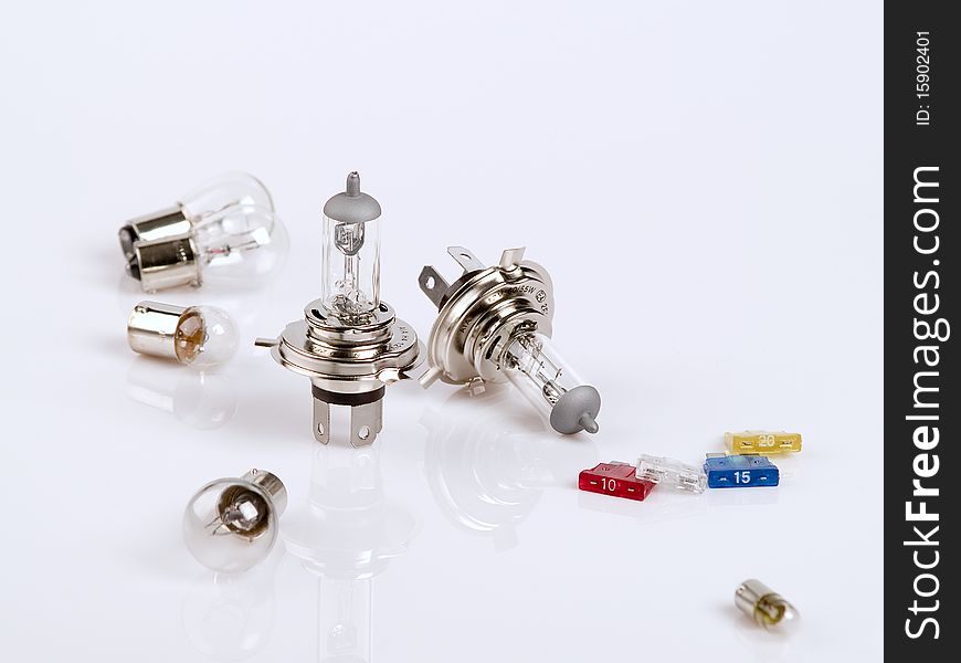 The photo shows spare bulbs and some fuses over white