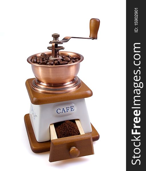 White coffee grinder with coffee grains