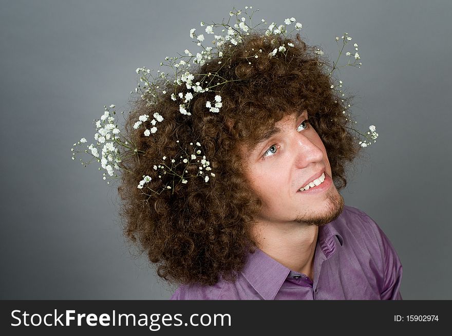 Young Man With Flowers In Curly Hair