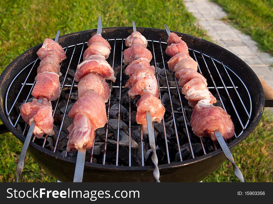 Meat preparation on a barbecue on the nature in the open air