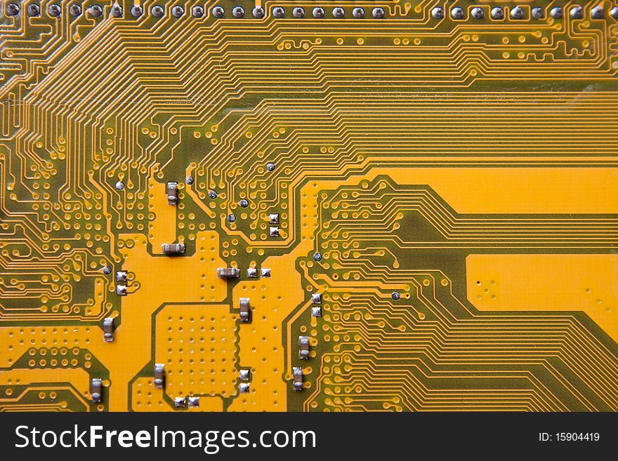 Part of a circuit board showing some capacitors, resistors as well as data paths and power trails.