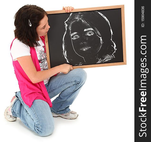 Beautiful american 12 year old girl with chalkboard drawing of herself over white. Beautiful american 12 year old girl with chalkboard drawing of herself over white.