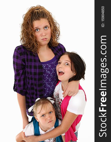 Adorable american sisters making silly faces over white background. Adorable american sisters making silly faces over white background.