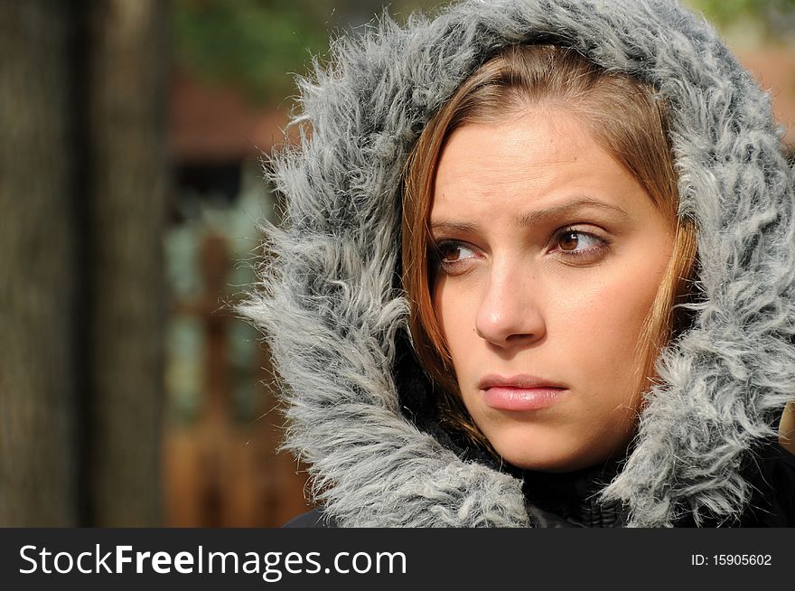 Adult female wearing a winter coat in cool fall weather.