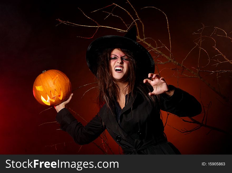 Beautiful woman with a pumpkin in the hands. Beautiful woman with a pumpkin in the hands