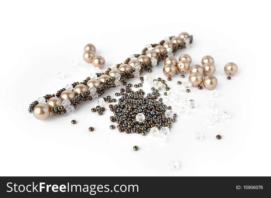 Brown pearl bracelet beading tools isolated on white background