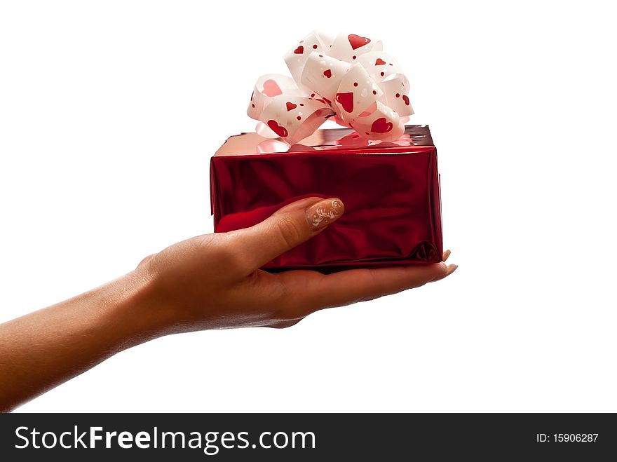 Hand with a red gift box with bow isolated on white background. Hand with a red gift box with bow isolated on white background