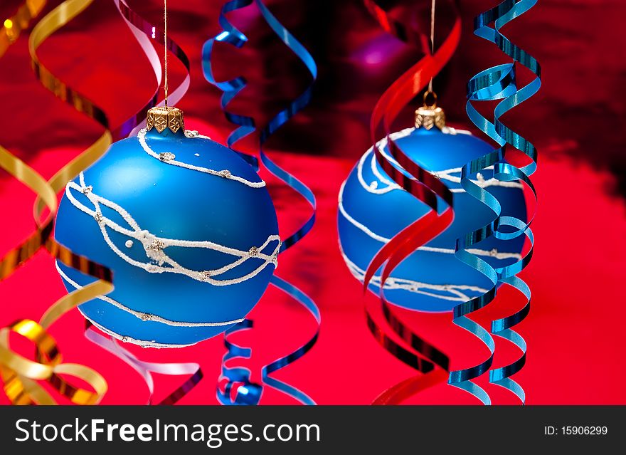 Christmas decoration from two blue balls on red background. Christmas decoration from two blue balls on red background