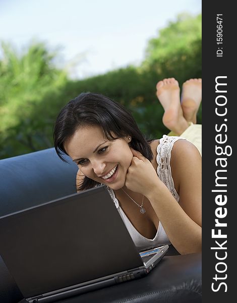 Portrait of woman with laptopm in summer environment. Portrait of woman with laptopm in summer environment