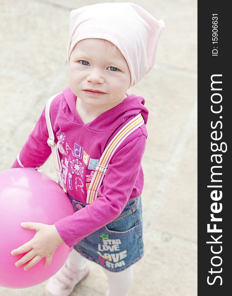 Portrait of toddler with pink balloon