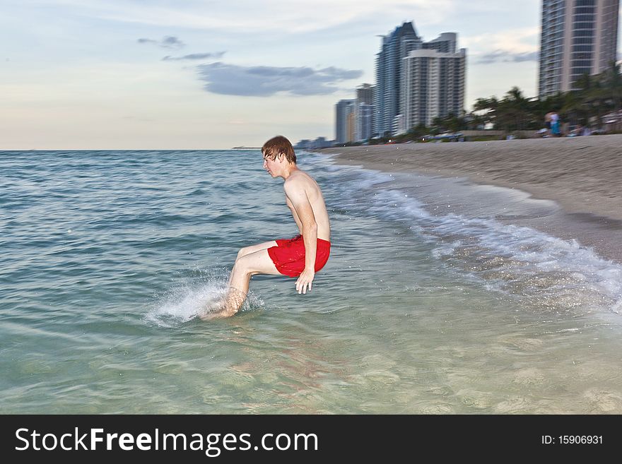 Boy jumps with speed into the ocean