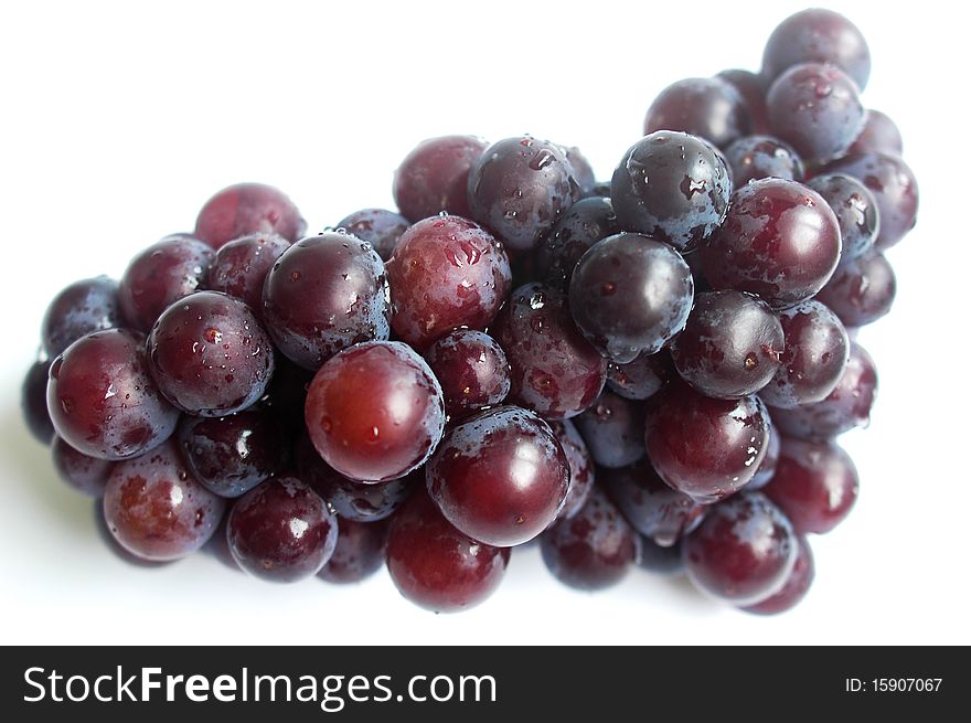 A cluster of fresh grapes isolated on a white background.